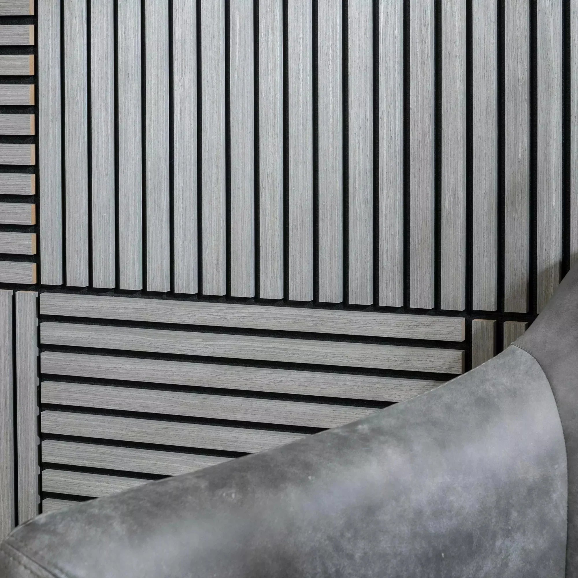 3D decorative close-up of a square ash grey acoustic wall panel by Solid Furniture LTD showing wood slat texture, gap spacing, and felt backing for sound absorption