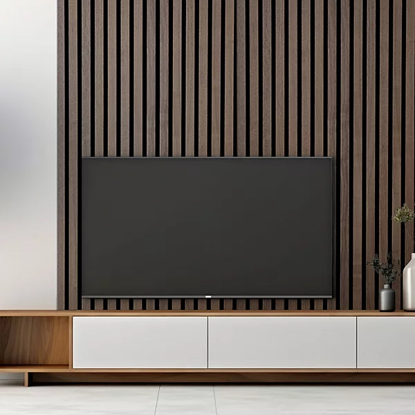 Walnut acoustic wall panels 60x240 by Solid Furniture UK installed in a modern TV lounge creating a warm, stylish entertainment feature wall with improved sound comfort
