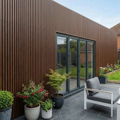 Walnut WPC slatted wall panel 30x240cm installed outdoors – Solid Furniture UK