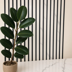 Full wall installation of white marble acoustic slatted panels creating a modern feature wall in interior space solid furniture UK