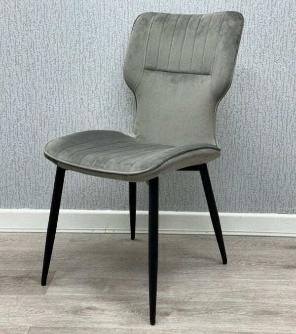 Side view of Grey Windsor Velvet Dining Chairs highlighting the modern shape and metal frame from Solid Furniture UK