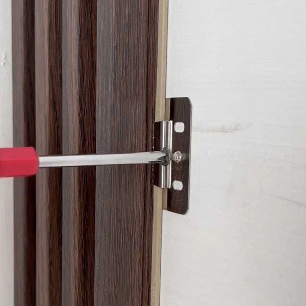 Installing WPC wall panel bracket using a screwdriver from Solid Furniture UK for precise and manual secure fixing on wall surface
