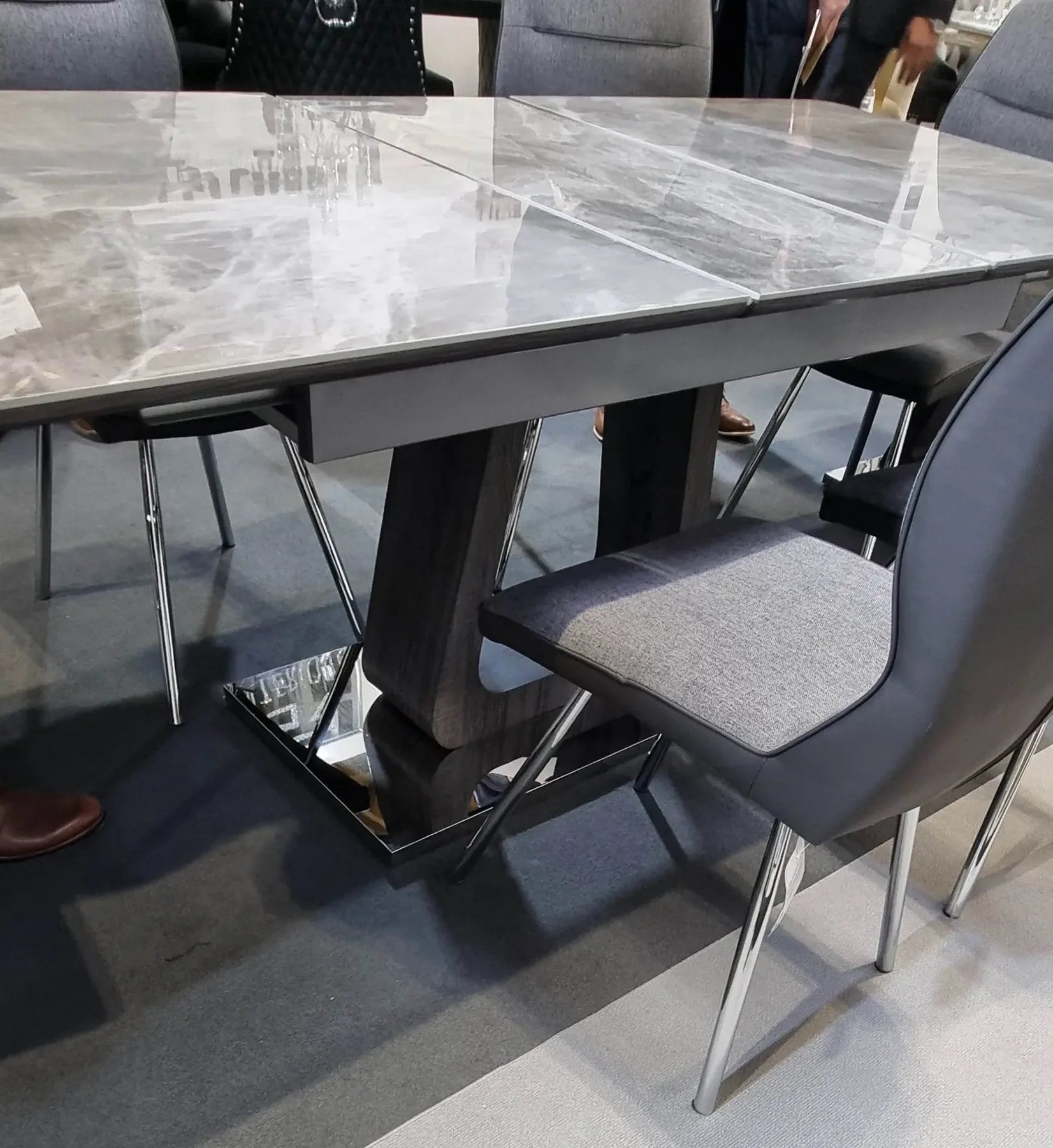 Side view of Zermatt extendable dining table showing extension mechanism and sleek grey ceramic marble effect design from Solid Furniture UK