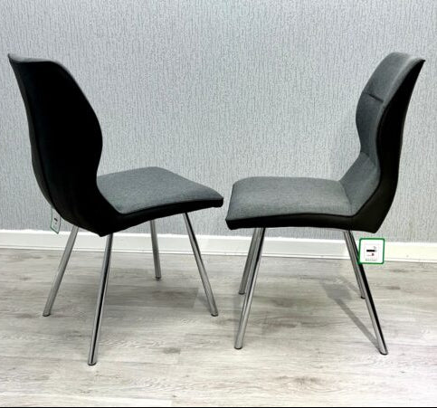 Pair of Zermatt grey dining chairs side view showing upholstered design and chrome legs from Solid Furniture UK